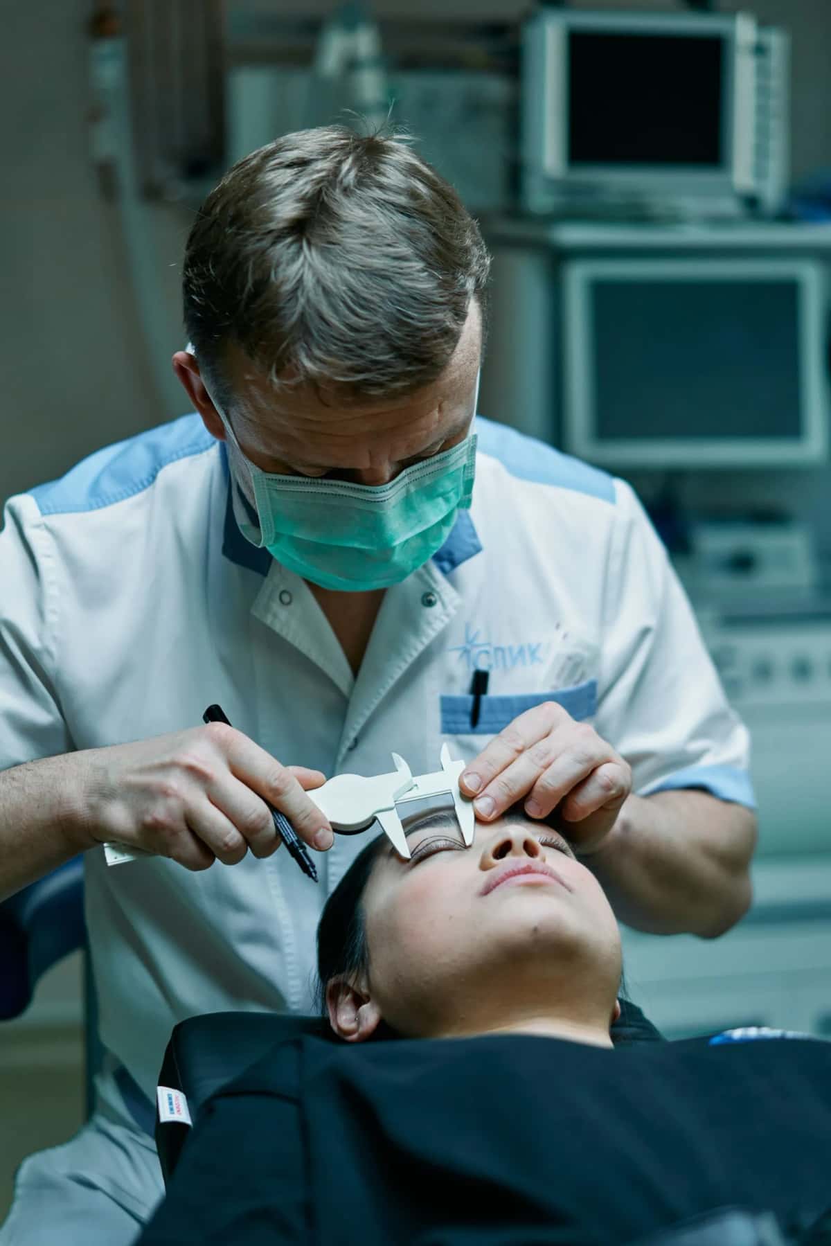 Chirurgien plasticien mesurant le patient avant une intervention esthétique