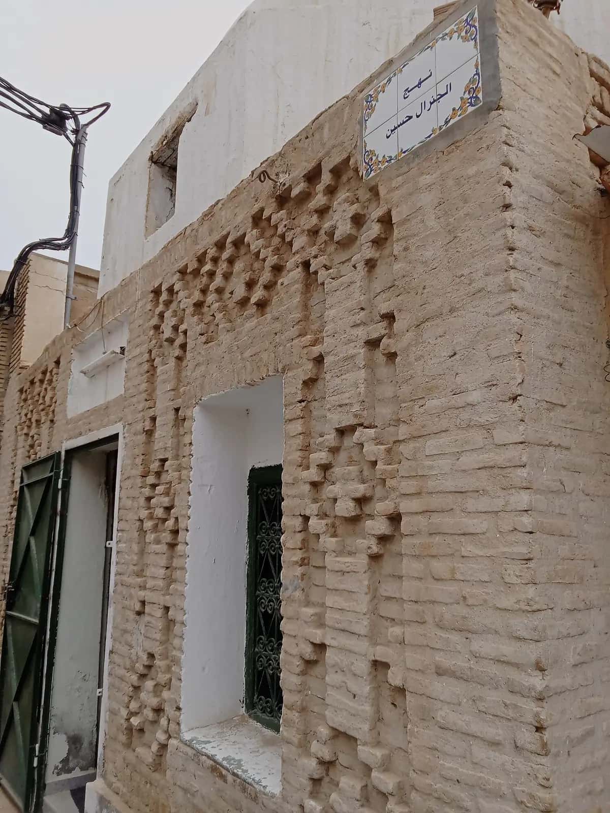 Détail d'un mur en briques d'argile posées en relief, dans la médina de Tozeur