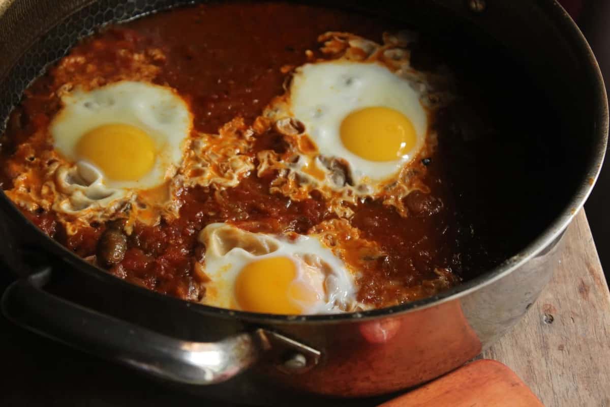 Œufs cuits dans une sauce tomate épicée, servis dans la poêle comme une ojja